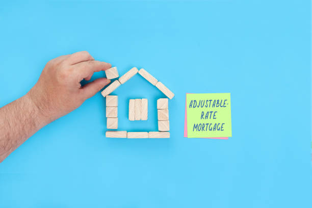 Handwritten words Adjustable rate mortgage A small house made of wooden blocks and sticky notes with the words Adjustable rate mortgage. adjustable stock pictures, royalty-free photos & images