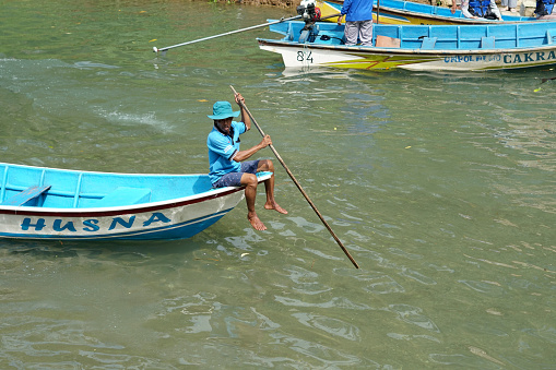 Yogyakatra, Indonesia - July 05, 2022: people riding boats in the Maron river tourist area, Pacitan - East Java