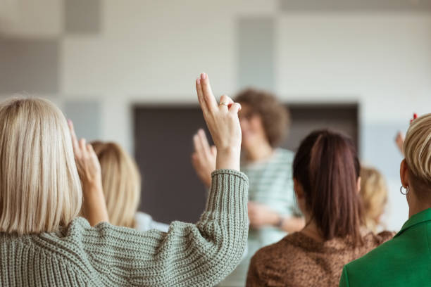 istock Women voting during seminar 1406953717