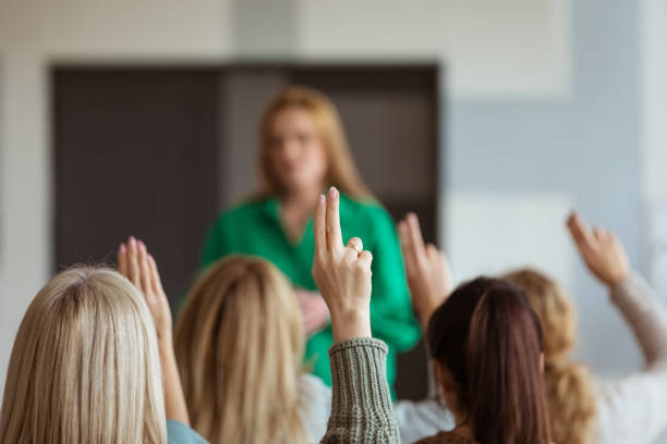 istock Women voting during seminar 1406953842