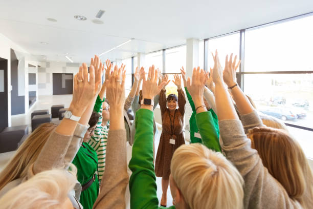 istock Group of women at the training raising hands together 1406955151