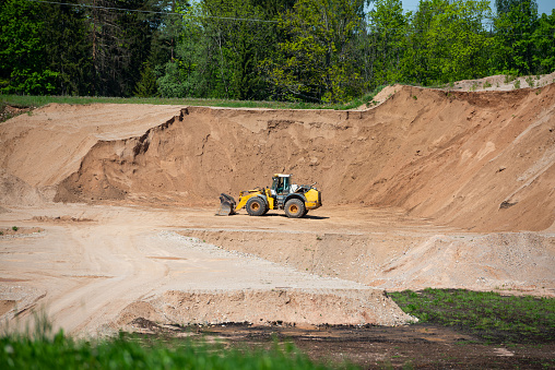 Quarry aggregate with heavy duty machinery. Construction industry. Horizontal