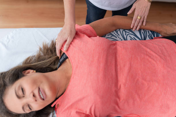 istock Woman with relaxed expression receiving a reiki treatment 1406958066