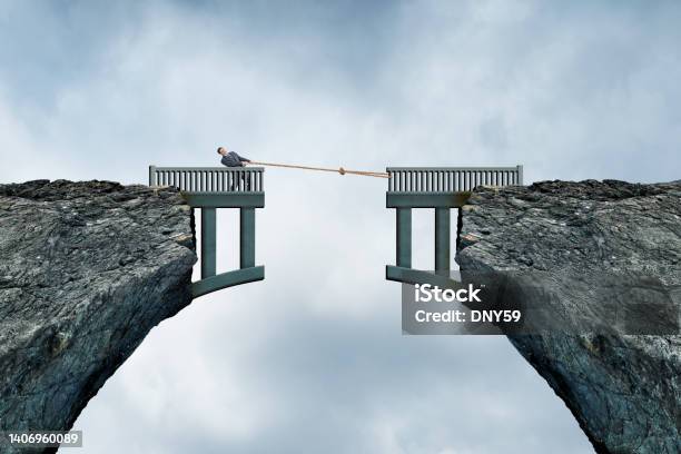 Man Using Rope To Bridge The Gap Stock Photo - Download Image Now - Separation, Bridge - Built Structure, Broken