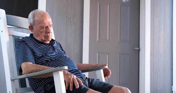 Old man sitting in a rocking chair sleeping Old man sitting in a rocking chair sleeping man sleeping chair stock pictures, royalty-free photos & images