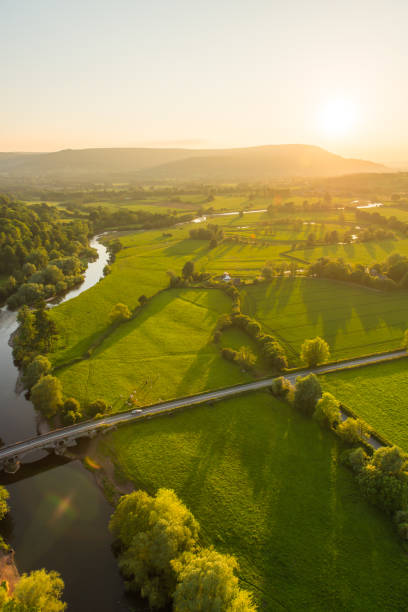 aerial photograph river rural road idyllic green pasture mountain sunset - river usk imagens e fotografias de stock