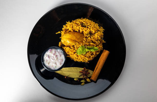 istock Chicken biryani Spicy Indian Malabar biryani Hyderabadi biryani pulao with egg. Beautiful shot of Kerala India Sri Lanka style biriyani made of basmati rice 1406963378