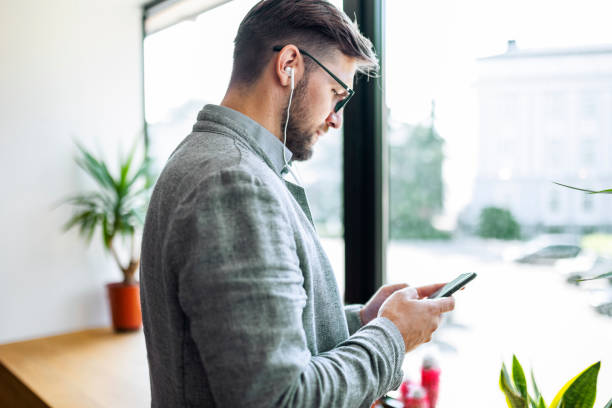 istock Businessman in office text messaging 1406967000