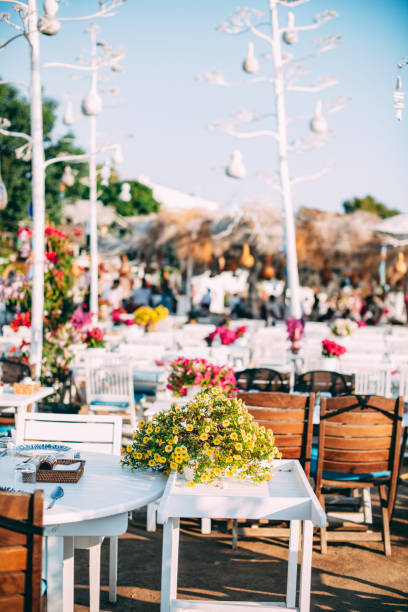 istock Dining Table Decorated With Flowers by the Sea 1406968637