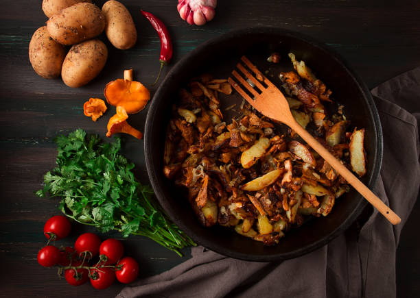 istock Fried chanterelles with mushrooms, in a clay pan, close-up, top view, selective focus, 1406968790