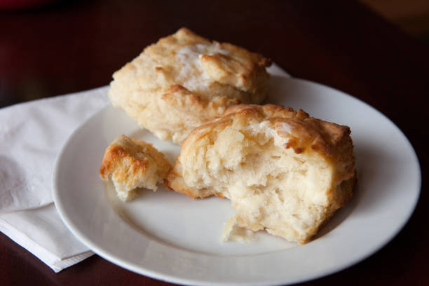 istock Biscuit Torn Open on a Simple White Plate with Melted Butter on Top 1406979180