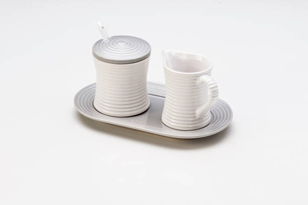 White grooved ceramic kit with a sugar bowl and a small jar, isolated on white