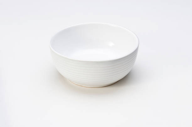 istock Simple empty ceramic white bowl with grooved lines, isolated on white 1406981534