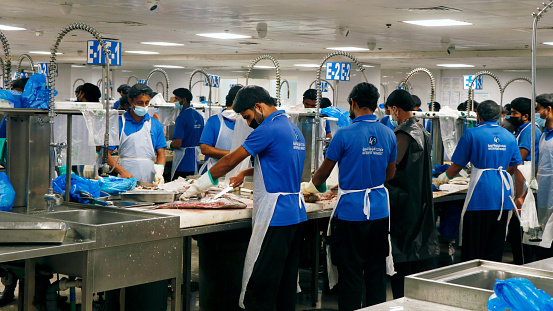 Dubai, United Arab Emirates - May 21, 2019 people working in deira fish market in dubai