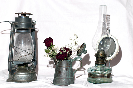 antique vintage kerosene lamp and copper jug, white background