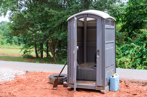 On a construction site, workers use a portable restroom for their convenience