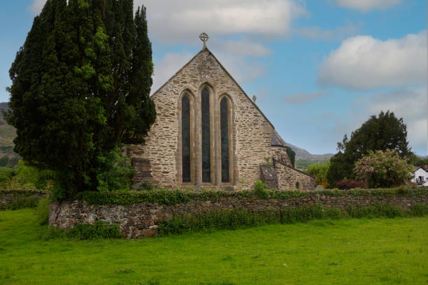 красивая старая каменная церковь и кладбище в сельской местности уэльса великобритания - wales stone cross religion стоковые фото и изображения