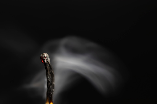 smoking matchsticks. close-up, black background.