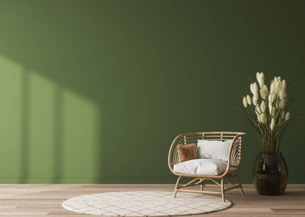 Empty wall mock-up in home interior on green background with rattan chair stock photo