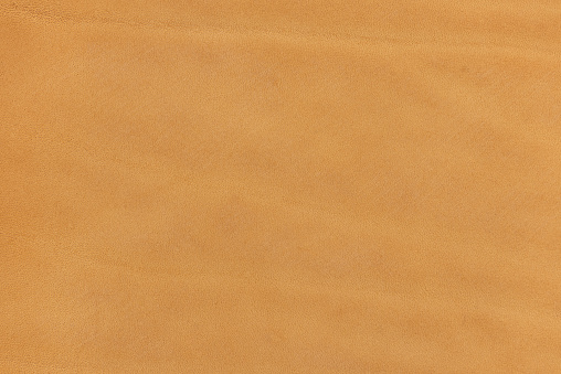 Leather. Close up beige color suede texture background