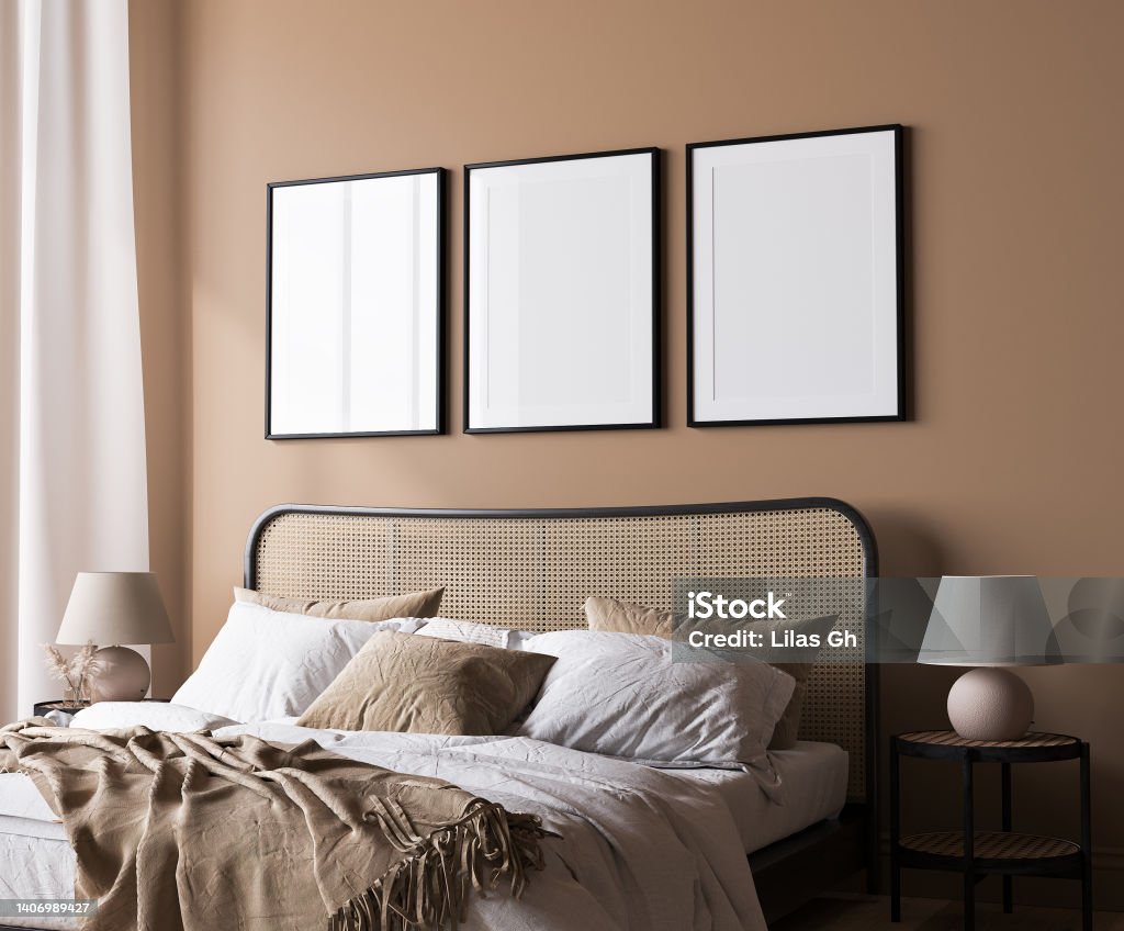 Bright bedroom mockup, rattan wooden bed in a beige background, poster frame mock up Bright bedroom mockup, rattan wooden bed in a beige background, poster frame mock up in a neutral colors room interior, 3d render Picture Frame Stock Photo