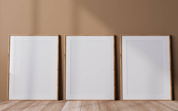 istock Poster frame mock up in neutral colors interior, three wooden frames in a beige background 1406989446