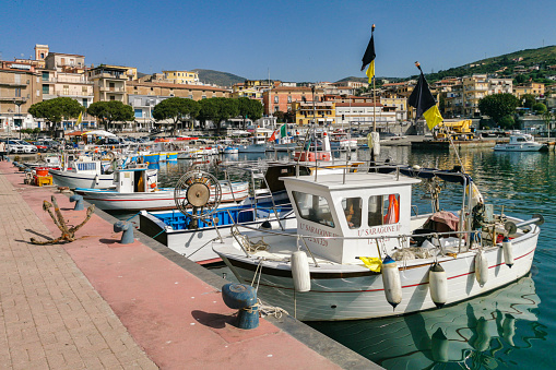 Colorful fishing boats moored at Marina di Camerota port. Marina di Camerota, Campania, Italy, June 2022