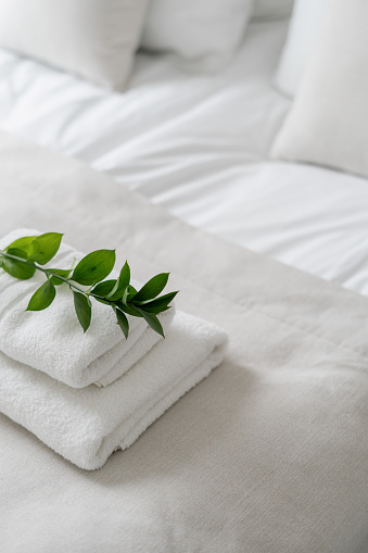 High above view of white fresh towels in modern hotel room interior design, concept of cleanliness, personal hygiene, wellness and relax, laundered fluffy towels