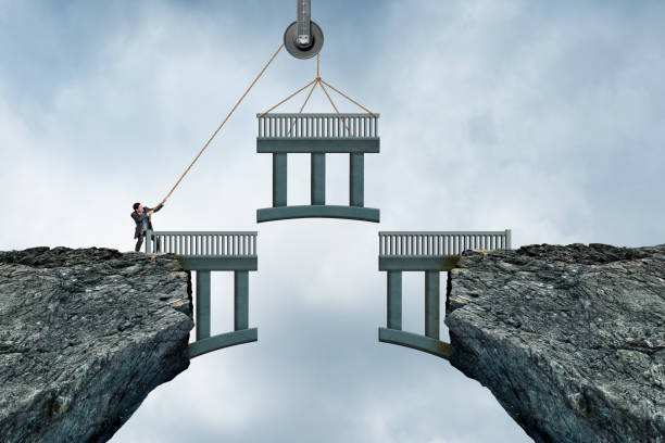istock Man Lifts Missing Piece Of Bridge into Place 1406990642