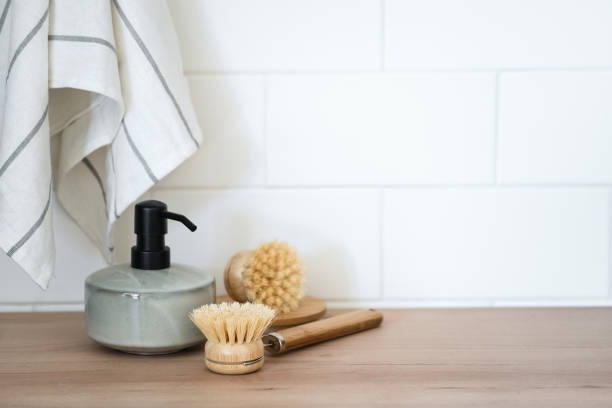 istock Eco-friendly dishwashing brushes and detergent on table 1406991220