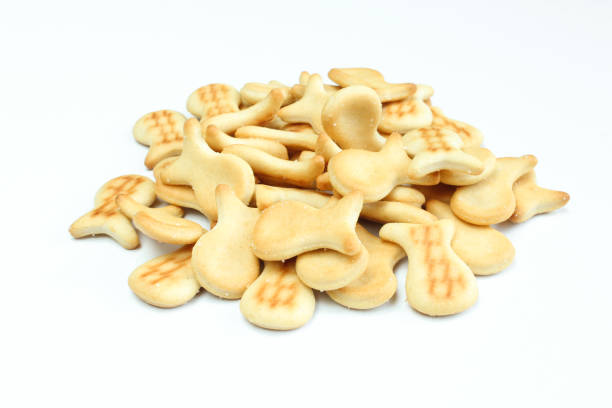 istock Pile of salty crackers isolated on white background. Fish shaped snack 1406991322