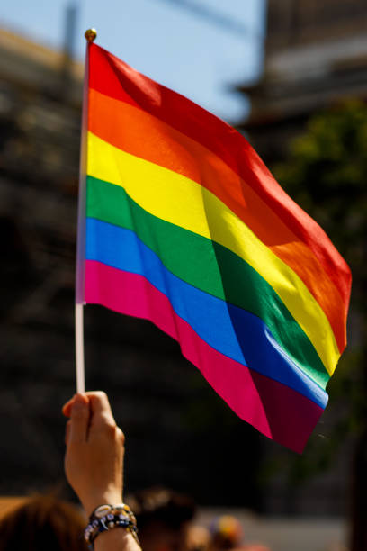 istock Lgbt pride rainbow flag during parade in the city . 1406992946