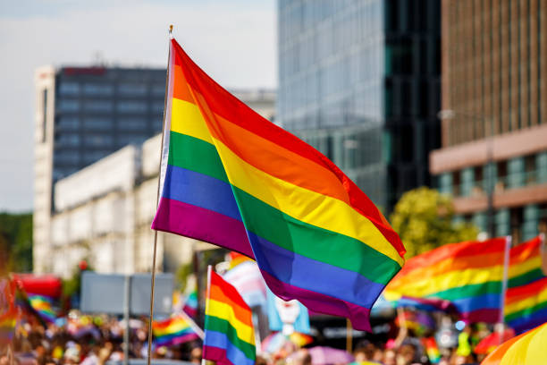 istock Lgbt pride rainbow flag during parade in the city . 1406992968