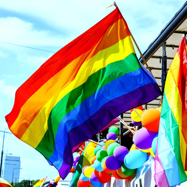 istock Lgbt pride rainbow flag during parade in the city . 1406992975