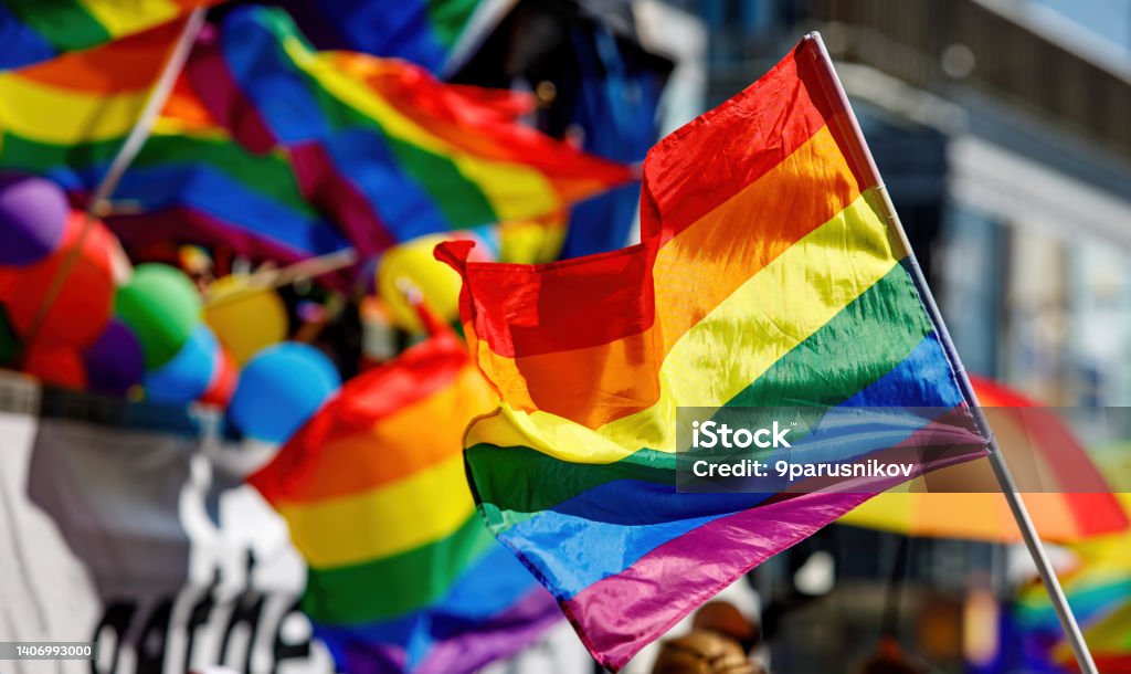 Lgbt pride rainbow flag during parade in the city . Lgbt pride rainbow flag during parade in the city LGBTQIA Pride Event Stock Photo