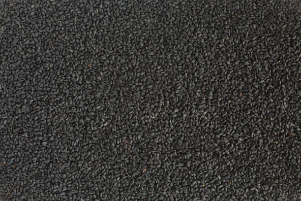 Background full of black cumin. Nigella sativa seasoning texture