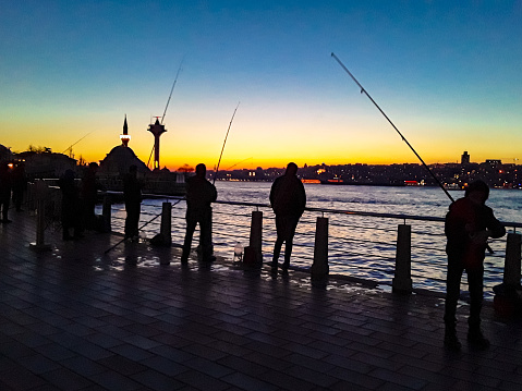 People fishing on the banks of the Bosphorus in Istanbul Üsküdar.