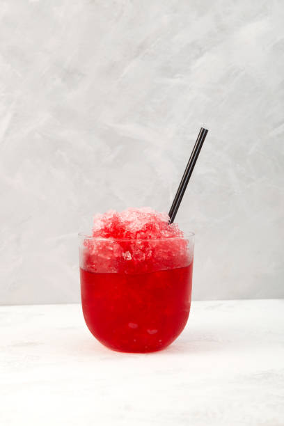 Red Slush. Spanish fruit granizado drink. Sweet Shaved ice. Glass of Refreshing summer iced drink. Vertical orientation, copy space Red Slush. Spanish fruit granizado drink. Sweet Shaved ice. Glass of Refreshing summer iced drink. Vertical orientation, copy space. strawberry crush stock pictures, royalty-free photos & images