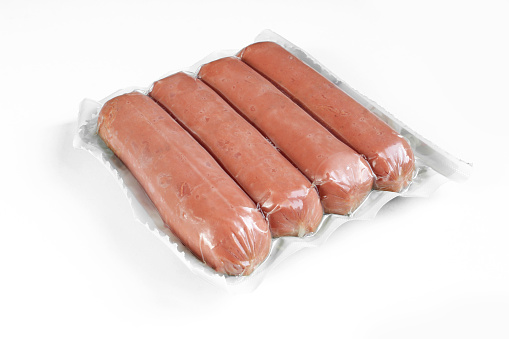 Sausages in plastic wrap package isolated on white background.
