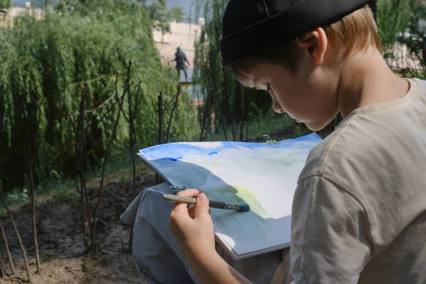 istock school age boy love to paint in parks 1406994551