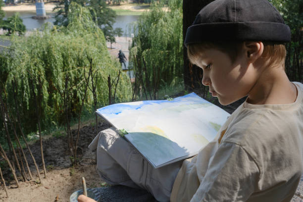 istock school age boy love to paint in parks 1406994560