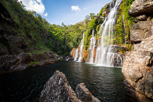 Beautiful view to big wild green rocky waterfall in São Jorge, State of Goiás, Brazil