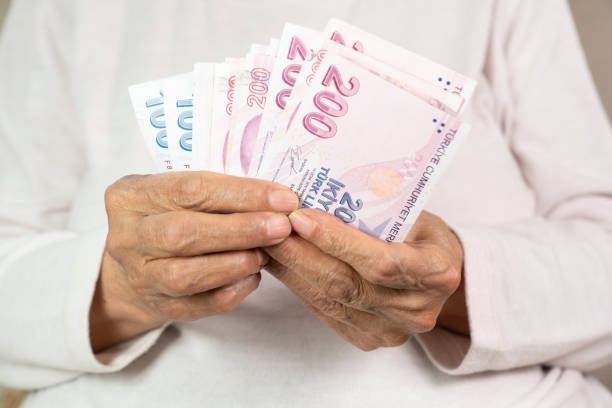 istock old woman counting Turkish coins in his hand 1406995014