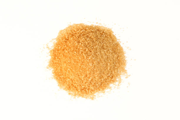 istock Pile of brown sugar isolated on white background. Above view 1406996247