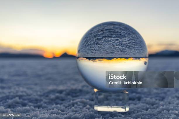 Crystal Ball Macro Closeup Of View In Round Glass Globe On Stand With Reflection Of Bonneville Salt Flats And Mountains At Colorful Sunset In Utah Desert Landscape Stock Photo - Download Image Now