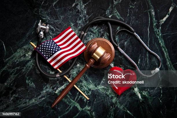Health Care And Legal Concept With Stethoscope On Green Marble Background Stock Photo - Download Image Now