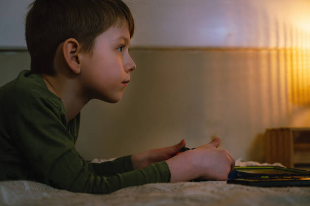 istock Kids playing video games at home on console 1406997633