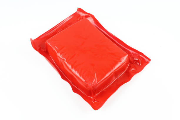 istock Back side of plastic foil wrap cheese packaging isolated on white background. Red square shaped pack 1406998260