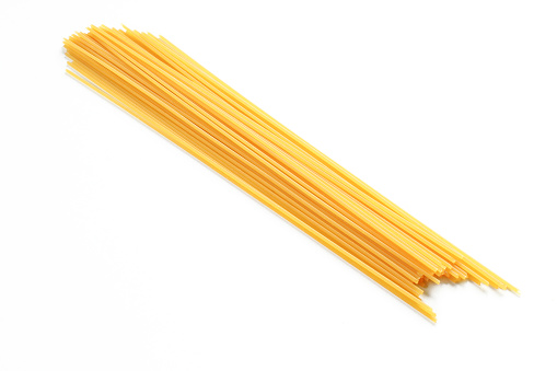 Bunch of uncooked raw spaghetti pasta isolated on white background
