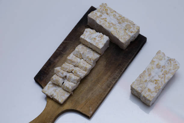 istock Tempeh pieces on a wooden base in a rectangular shape isolated on a white background 1406999667